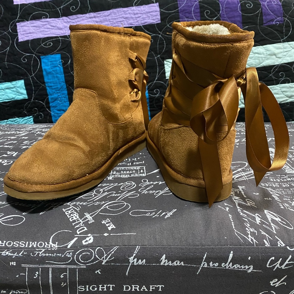 Torrid faux fur boots with laced backed bows